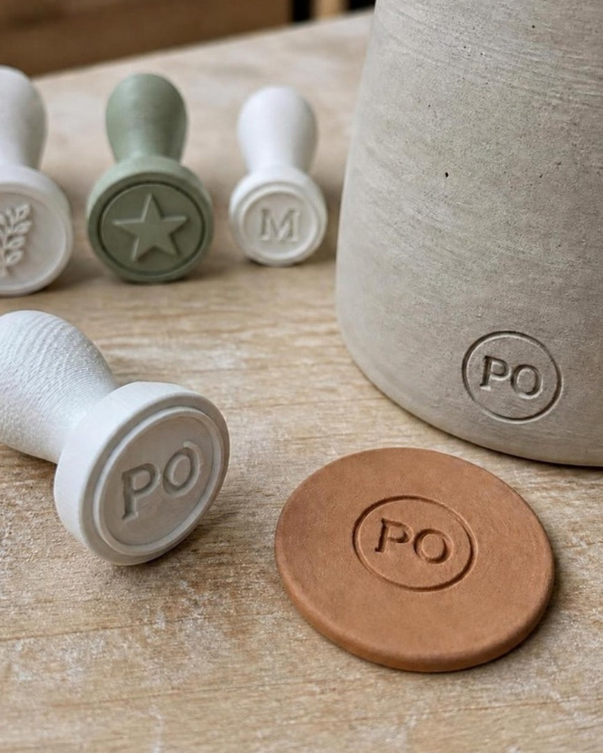 Custom 3D printed maker's mark pottery stamp with PO monogram pressed into clay