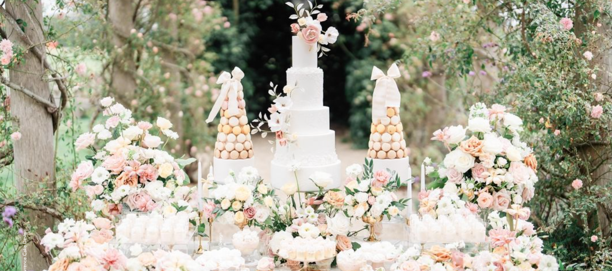 Modern summer wedding cake styled as a tiered centrepiece at an outdoor reception in bright daylight