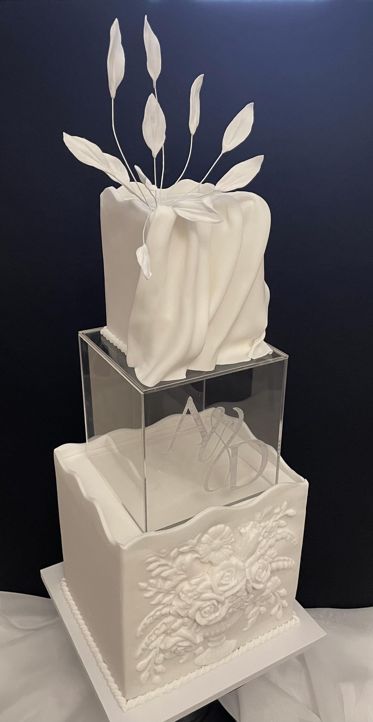 Clear acrylic square fillable cake separator by Prop Options shown close up