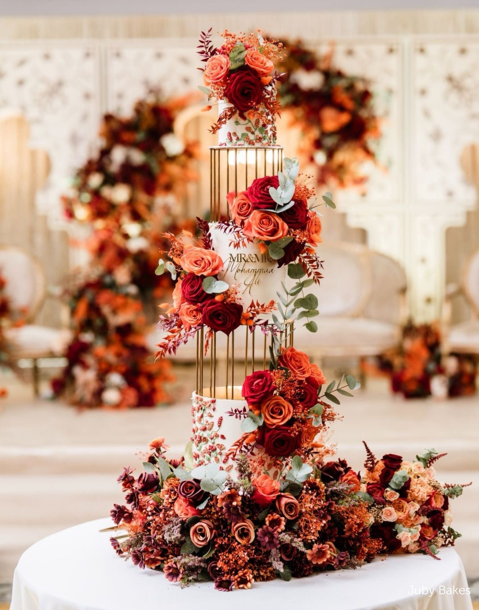 Gold birdcage metal cake separators used in a tall floral wedding cake display by Prop Options