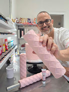 Victor Diaz holding a sheet of pink fondant rolled with the Quilted diamond pattern in front of a quilted cake - Prop Options