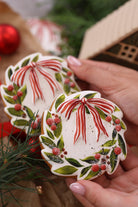 Wreath cookies decorated with a red bow and foliage