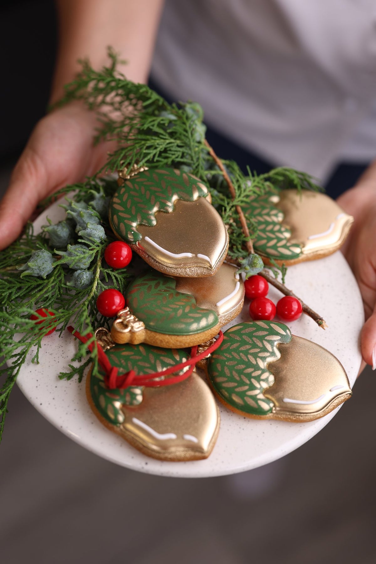 Green and gold acorn cookies with a knitted stencil pattern