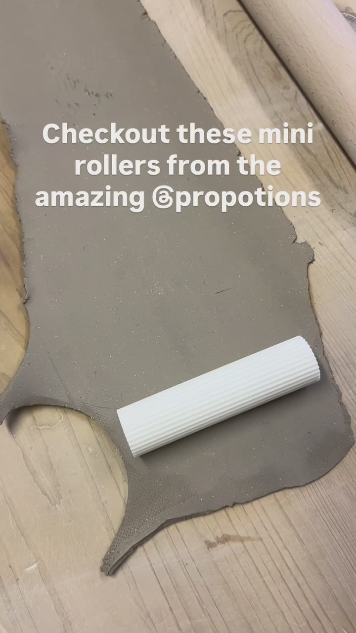 Karen Wiltshire rolling Prop Options mini clay texture rollers on a clay slab